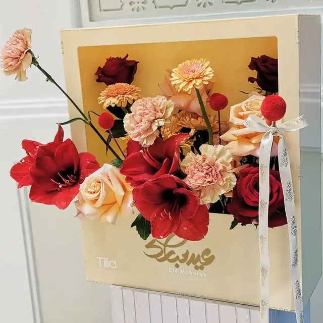 An Eid Mubarak frame box with red and peach flowers
