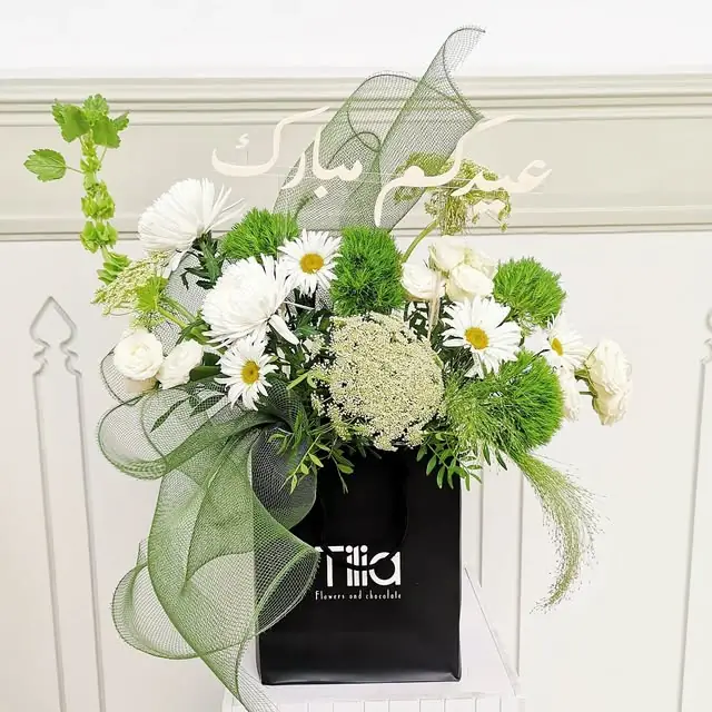 White and green flowers with sage mesh in a black Tilia box