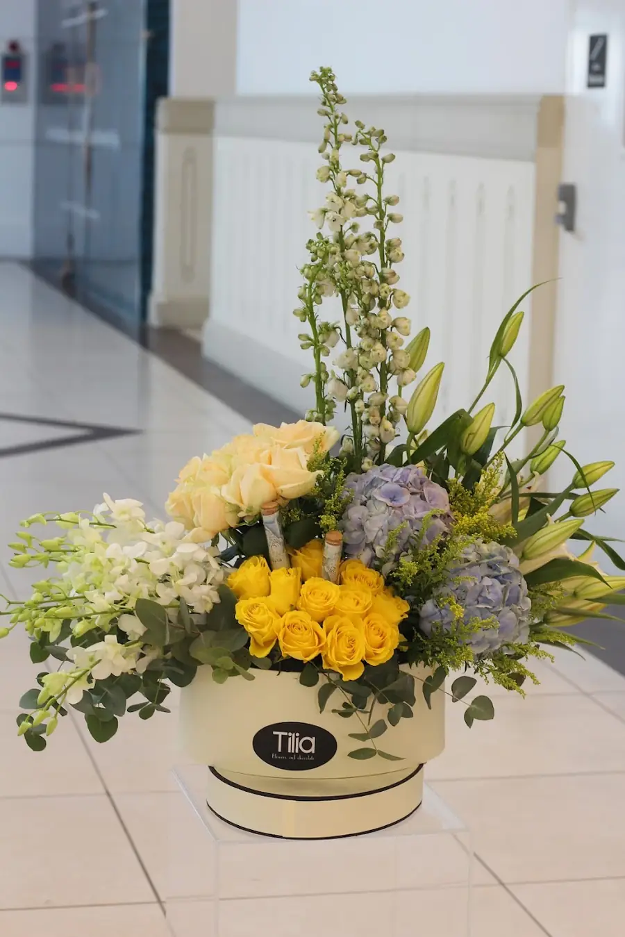 A cream hat box arrangement from Tilia